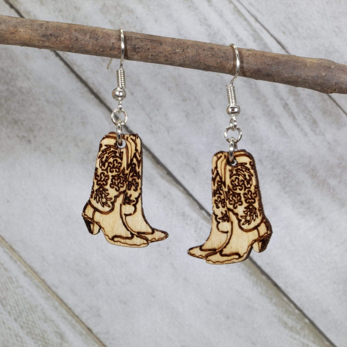 Hand-painted wooden cowboy boot dangle earrings with classic western design and hypoallergenic sterling silver hooks, rustic country statement jewelry earrings for rodeo and cowgirl style natural wood
