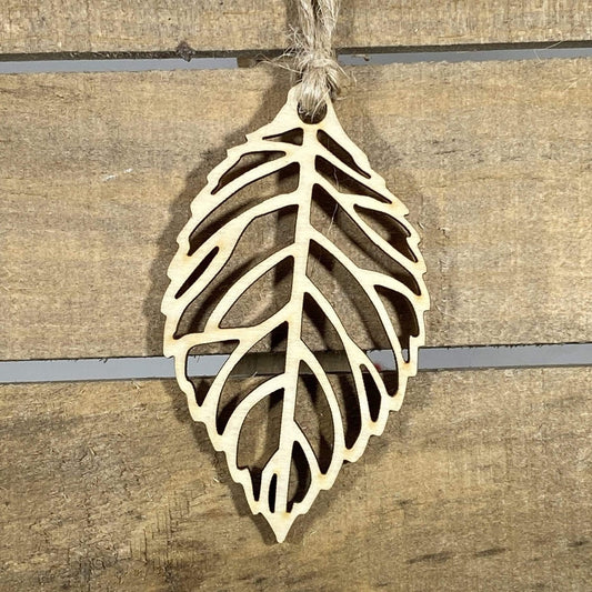 Hand-painted wooden cutout leaf Christmas ornament featuring an intricate nature-inspired leaf silhouette with detailed vein cutouts, elegant holiday decor for nature lovers and botanical enthusiasts by Cate’s Concepts