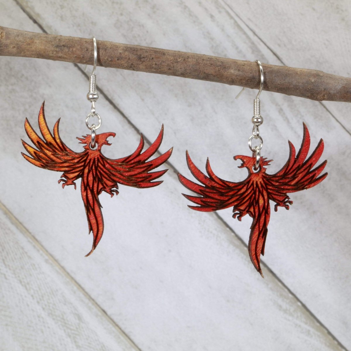Hand-painted wooden flaming phoenix dangle earrings with mythical fire bird design and hypoallergenic sterling silver hooks, fantasy phoenix statement jewelry earrings for mythology lovers 