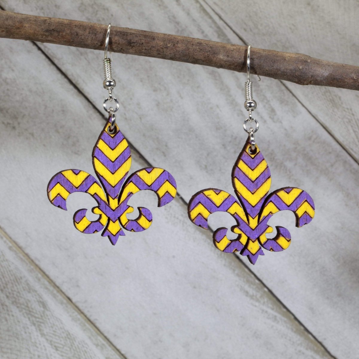 Hand-painted wooden fleur-de-lis dangle earrings with bold purple and gold Louisiana design and hypoallergenic sterling silver hooks, lightweight fleur-de-lis statement jewelry earrings for Mardi Gras style and southern pride
