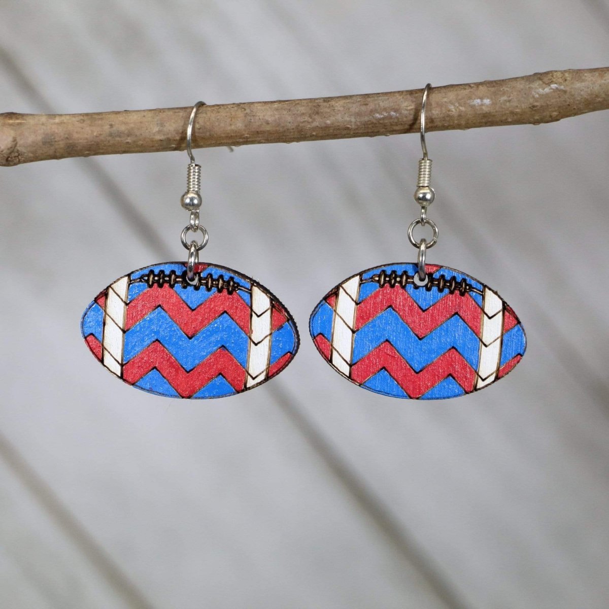 Hand-painted wooden football dangle earrings with chevron team spirit design and hypoallergenic sterling silver hooks, lightweight football statement jewelry earrings for players, fans, and football moms
