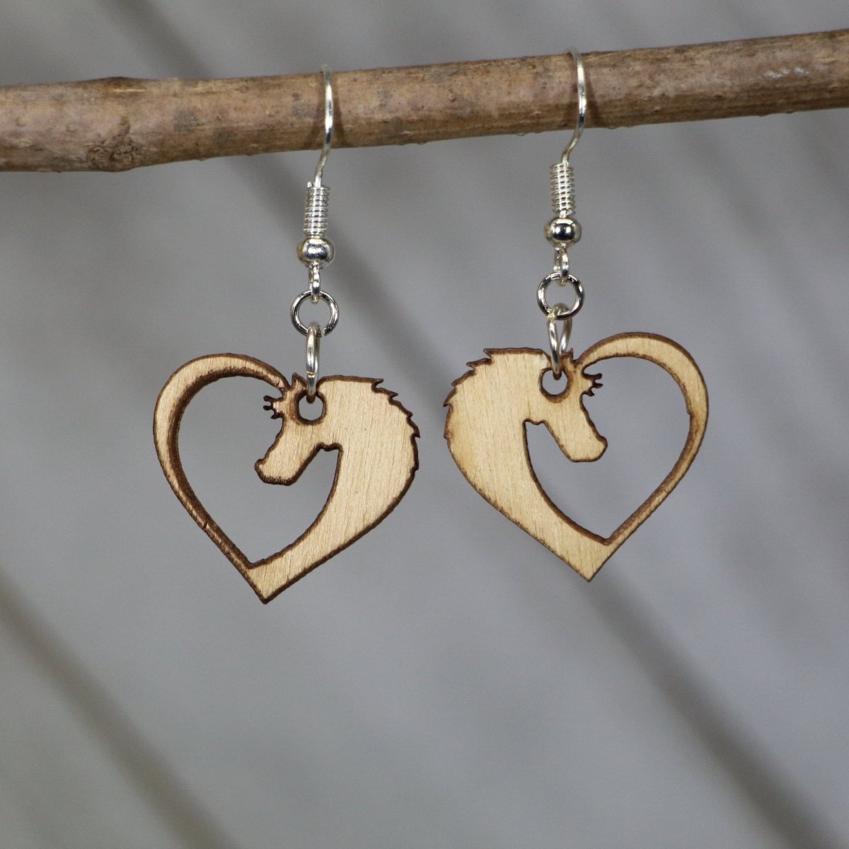 Hand-painted wooden horse heart dangle earrings featuring a romantic design with a horse silhouette forming a heart shape and hypoallergenic sterling silver hooks, lightweight jewelry for equestrians and horse lovers by Cate’s Concepts