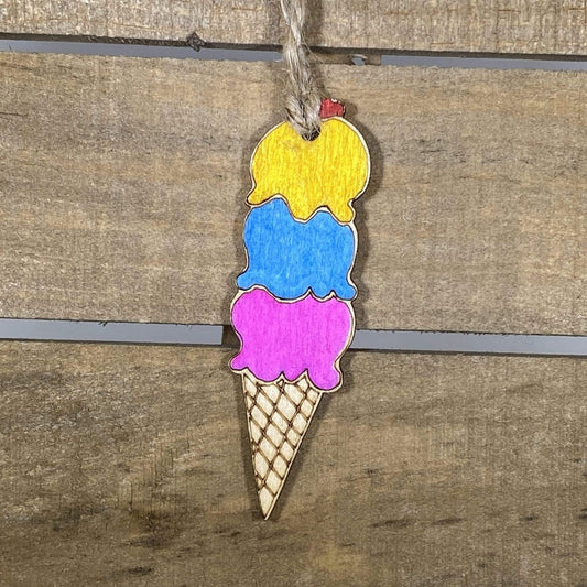 Hand-painted wooden ice cream cone Christmas ornament featuring a colorful scoop atop a classic cone with playful dessert details, festive holiday decor for sweet treat lovers and fun-loving homes by Cate’s Concepts