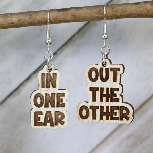 Hand-painted wooden “In One Ear Out the Other” dangle earrings with funny humor design and hypoallergenic sterling silver hooks, quirky novelty statement jewelry for playful personalities