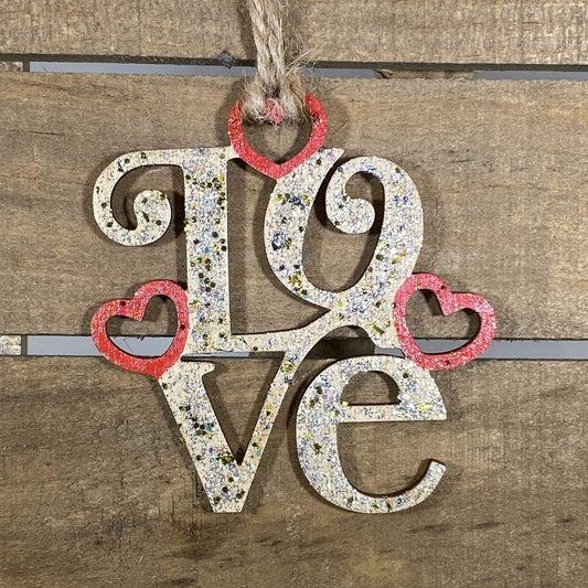 Hand-painted wooden LOVE Christmas ornament featuring bold romantic lettering with clean lines and decorative styling, meaningful holiday decor for couples and Valentine-inspired seasonal displays by Cate’s Concepts