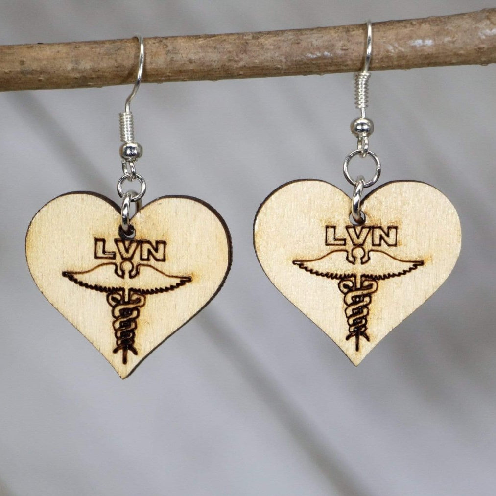 Hand-painted wooden LVN nurse dangle earrings featuring bold licensed vocational nurse lettering with clean medical-inspired design and hypoallergenic sterling silver hooks, lightweight jewelry for healthcare workers and nurse appreciation gifts by Cate’s Concepts