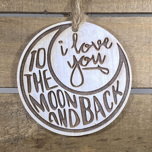 Hand-painted wooden love you to the moon and back Christmas ornament featuring a crescent moon design with heartfelt lettering and celestial details, sentimental holiday decor for couples and meaningful gift-giving by Cate’s Concepts