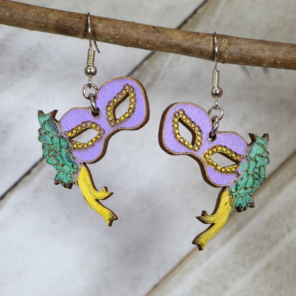 Hand-painted wooden Mardi Gras floral mask dangle earrings with festive carnival design and hypoallergenic sterling silver hooks, New Orleans statement jewelry for parade season and celebration lovers