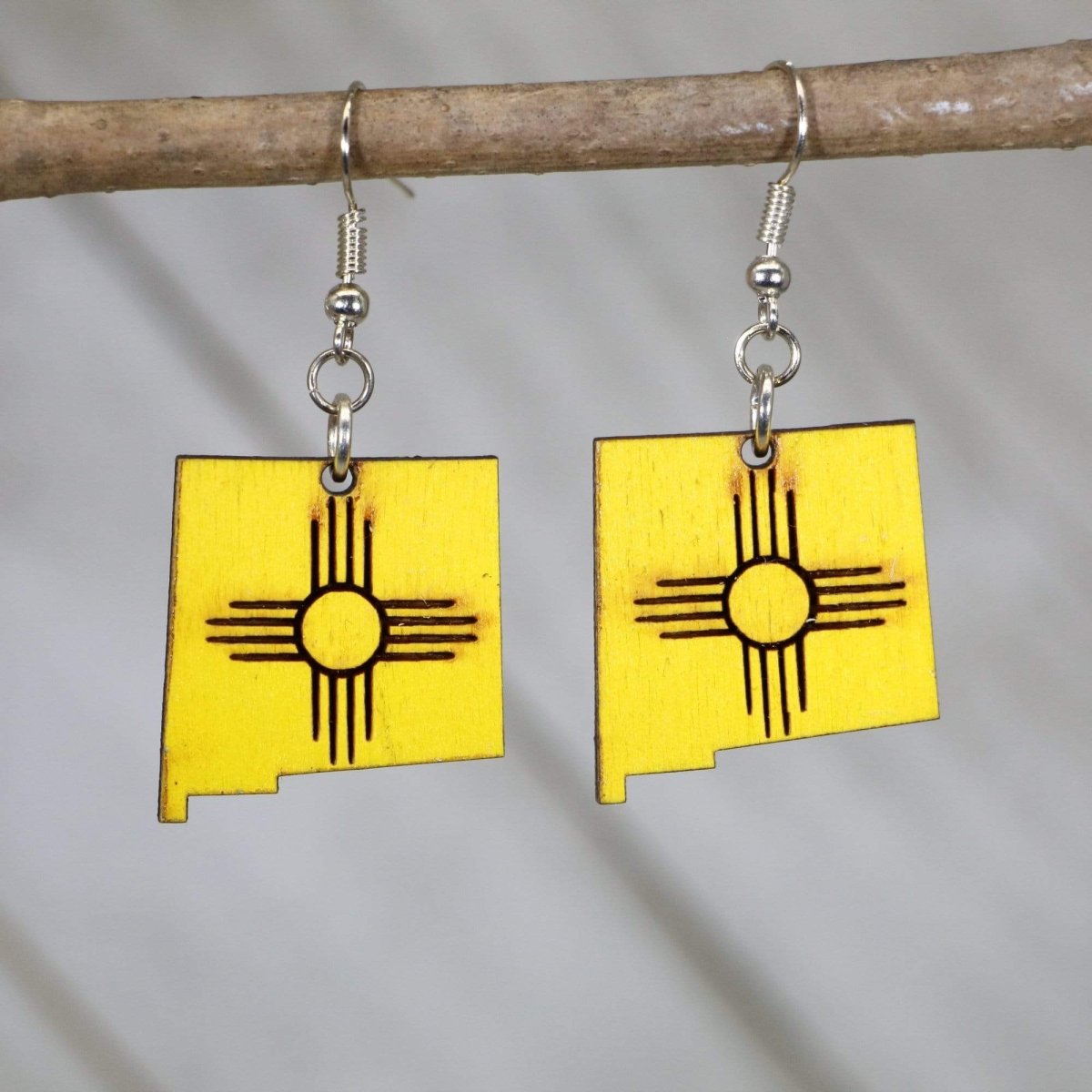 Hand-painted wooden New Mexico Zia symbol dangle earrings with iconic state sun design and hypoallergenic sterling silver hooks, lightweight Zia statement jewelry earrings for New Mexico pride and southwestern style