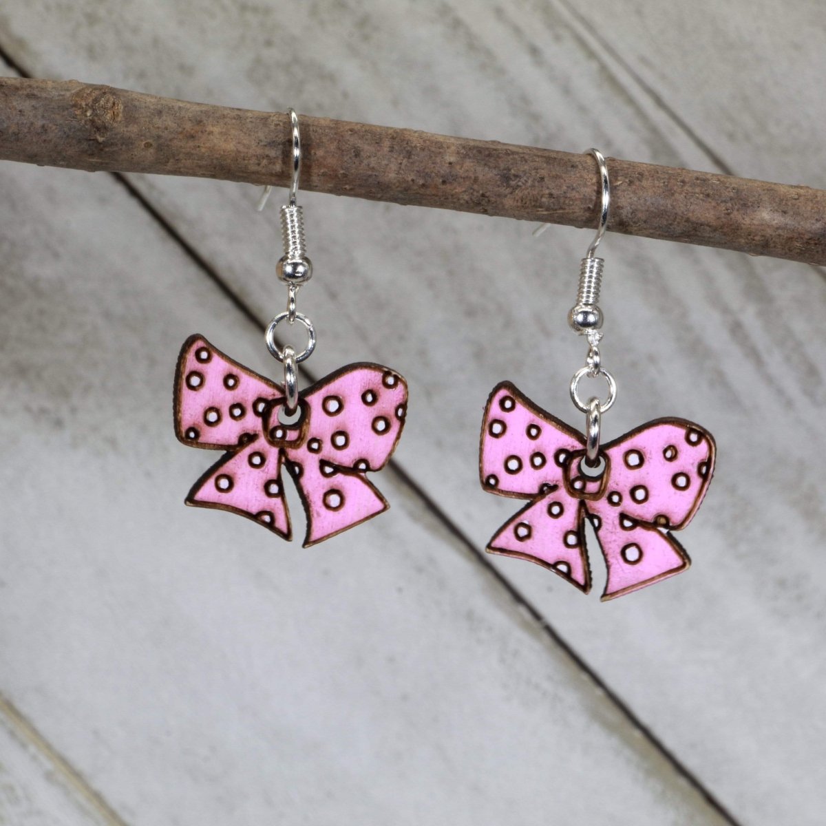 Hand-painted wooden pink bow dangle earrings with cute feminine design and hypoallergenic sterling silver hooks, lightweight bow statement jewelry earrings for playful style and everyday charm