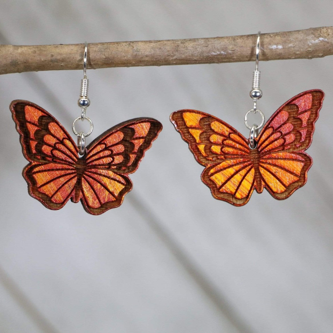 Hand-painted wooden monarch butterfly dangle earrings with realistic orange and black wing design and hypoallergenic sterling silver hooks, nature lover butterfly jewelry earrings