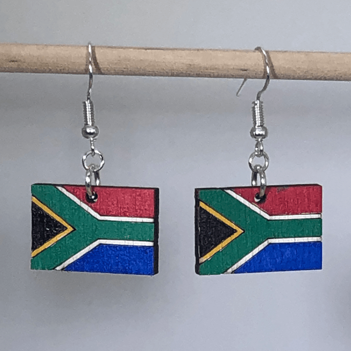 Hand-painted wooden South African flag dangle earrings featuring a vibrant multicolor flag design with bold geometric pattern and hypoallergenic sterling silver hooks, lightweight jewelry for travelers and cultural pride enthusiasts by Cate’s Concepts