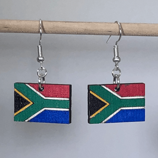 Hand-painted wooden South African flag dangle earrings featuring a vibrant multicolor flag design with bold geometric pattern and hypoallergenic sterling silver hooks, lightweight jewelry for travelers and cultural pride enthusiasts by Cate’s Concepts