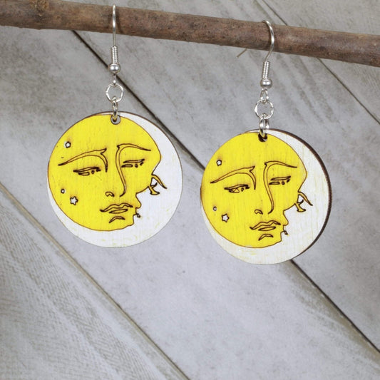 Hand-painted wooden sun and moon dangle earrings featuring a celestial yin yang design with contrasting sun and moon faces and hypoallergenic sterling silver hooks, lightweight jewelry for astrology lovers and boho style enthusiasts by Cate’s Concepts