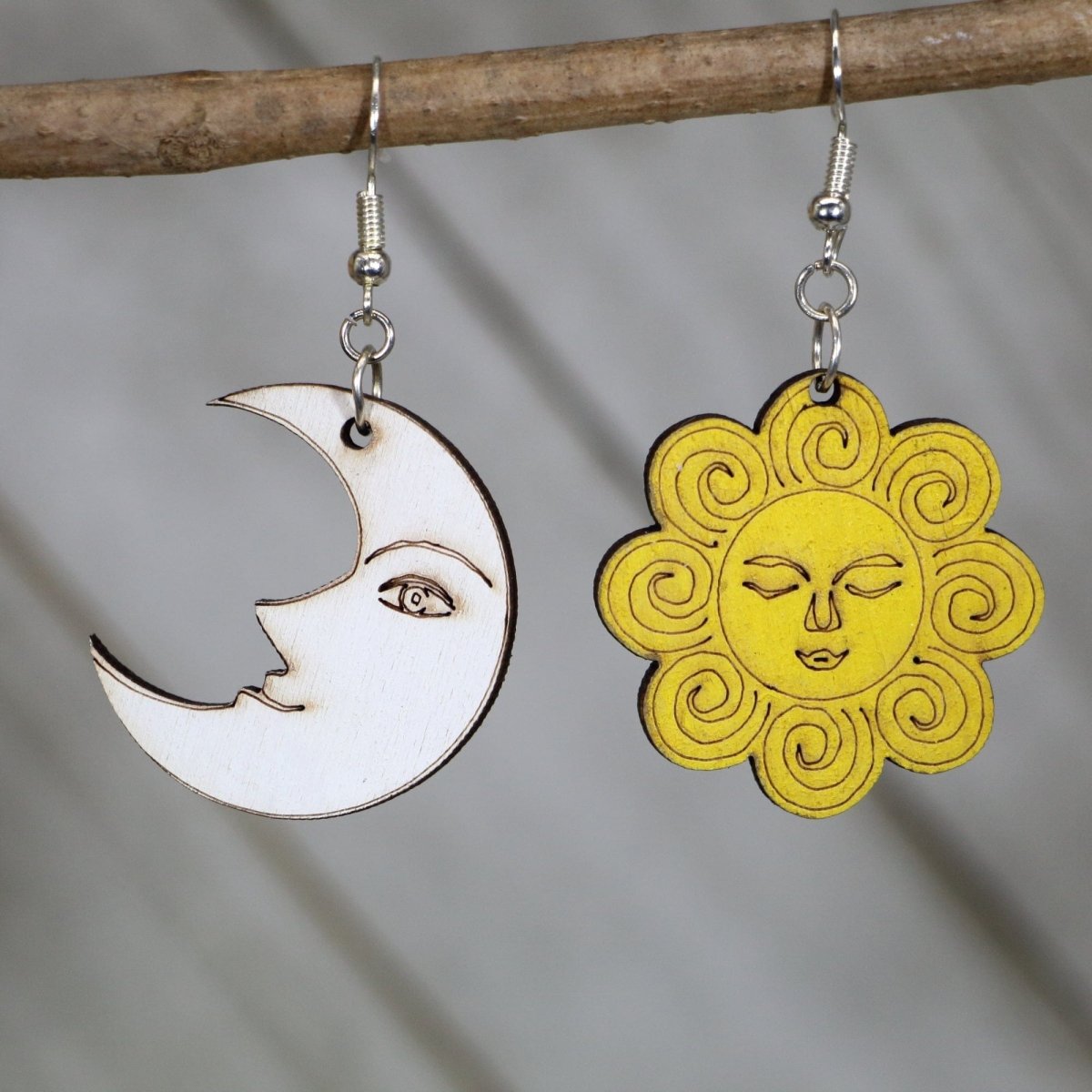 Hand-painted wooden sun and moon dangle earrings with celestial smiley face design and hypoallergenic sterling silver hooks, lightweight cosmic statement jewelry earrings for boho mystical and playful style