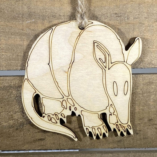 Hand-painted wooden Texas armadillo Christmas ornament featuring a quirky armored armadillo design with playful Southwestern style, funny holiday decor for Texas lovers and wildlife fans by Cate’s Concepts