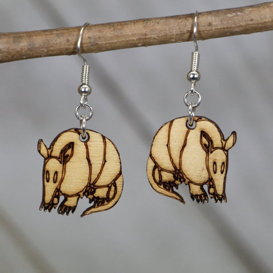 Hand-painted wooden Texas armadillo dangle earrings with realistic desert animal design and hypoallergenic sterling silver hooks, lightweight armadillo statement jewelry earrings for wildlife lovers and Texas style