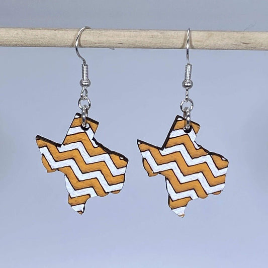Hand-painted wooden Texas orange white chevron dangle earrings featuring a bold state-shaped design with orange and white chevron pattern and hypoallergenic sterling silver hooks, lightweight jewelry for Texas fans and state pride enthusiasts by Cate’s Concepts
