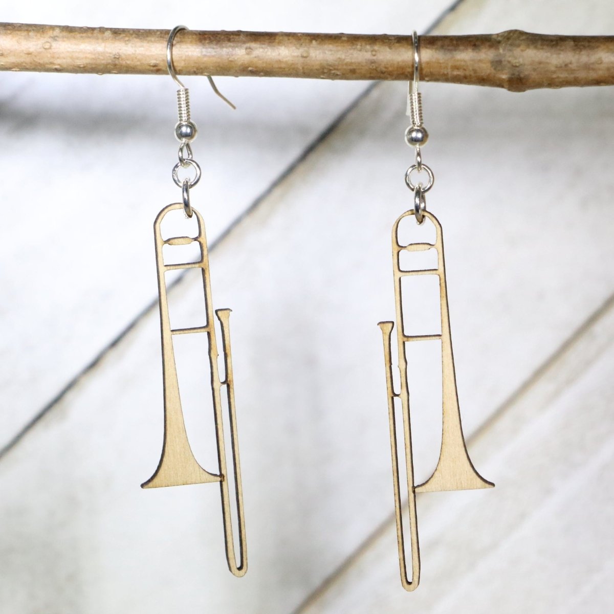 Hand-painted wooden trombone dangle earrings with detailed band instrument design and hypoallergenic sterling silver hooks, lightweight music jewelry for musicians, band students, and orchestra lovers