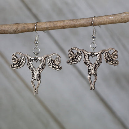 Hand-painted wooden uterus dangle earrings with bold anatomical design and hypoallergenic sterling silver hooks, feminist statement jewelry earrings for reproductive rights and anatomy lovers 