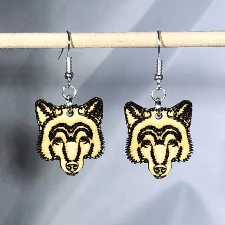Hand-painted wooden wolf dangle earrings featuring a detailed wildlife design with pointed ears and textured fur silhouette and hypoallergenic sterling silver hooks, lightweight jewelry for nature lovers and wolf enthusiasts by Cate’s Concepts
