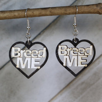 Hand-painted black wooden “Breed Me” dangle earrings with bold adult humor lettering and hypoallergenic sterling silver hooks, cheeky novelty statement jewelry earrings for playful edgy style