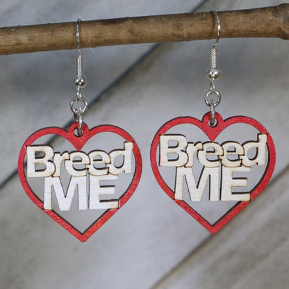 Hand-painted red wooden “Breed Me” dangle earrings with bold adult humor lettering and hypoallergenic sterling silver hooks, cheeky novelty statement jewelry earrings for playful edgy style